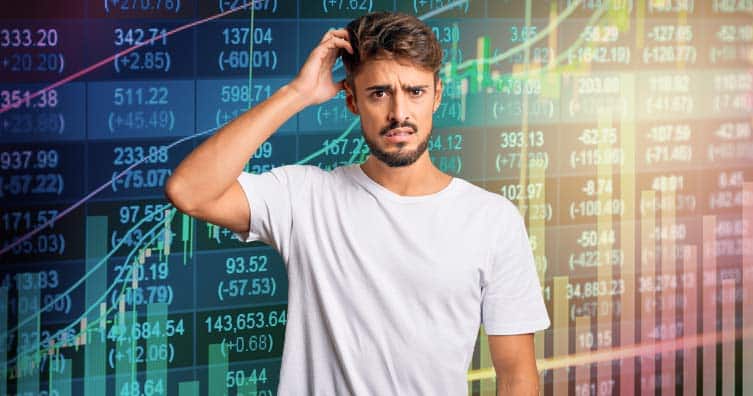 confused man in front stock market charts