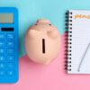 Calculator, piggy bank and notebook that says 'pension'