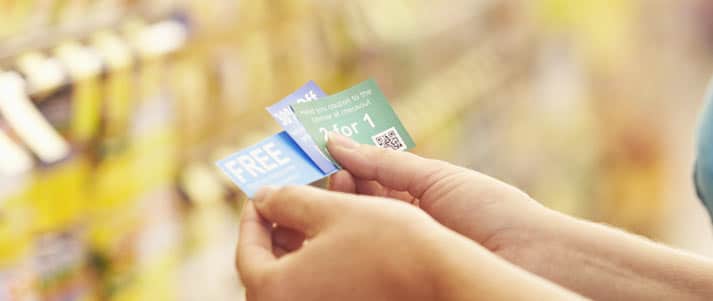person holding coupons