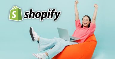Woman using a laptop with Shopify logo
