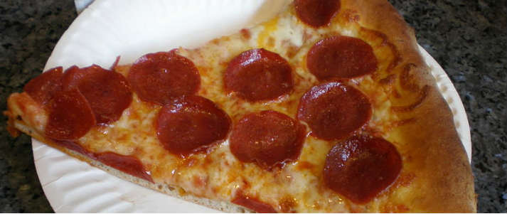 pizza slice on a paper plate
