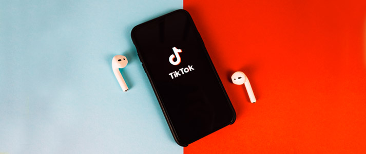 tiktok logo on phone and airpods