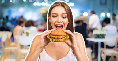 Woman eating a burger in a restaurant