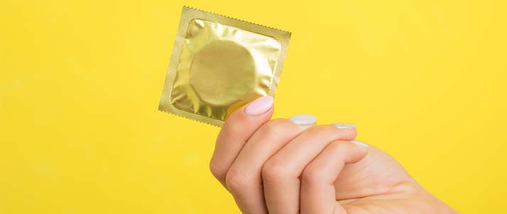 woman holding a condom